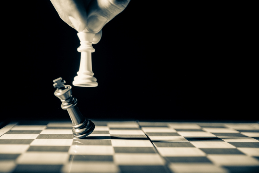 This is an image of a person who is taking out the black king on a chess board