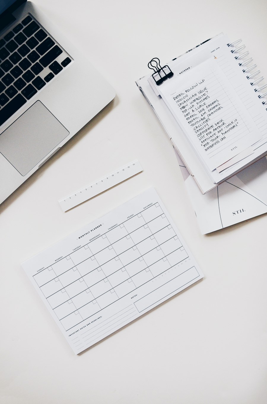 This is an image of a laptop, book and calander