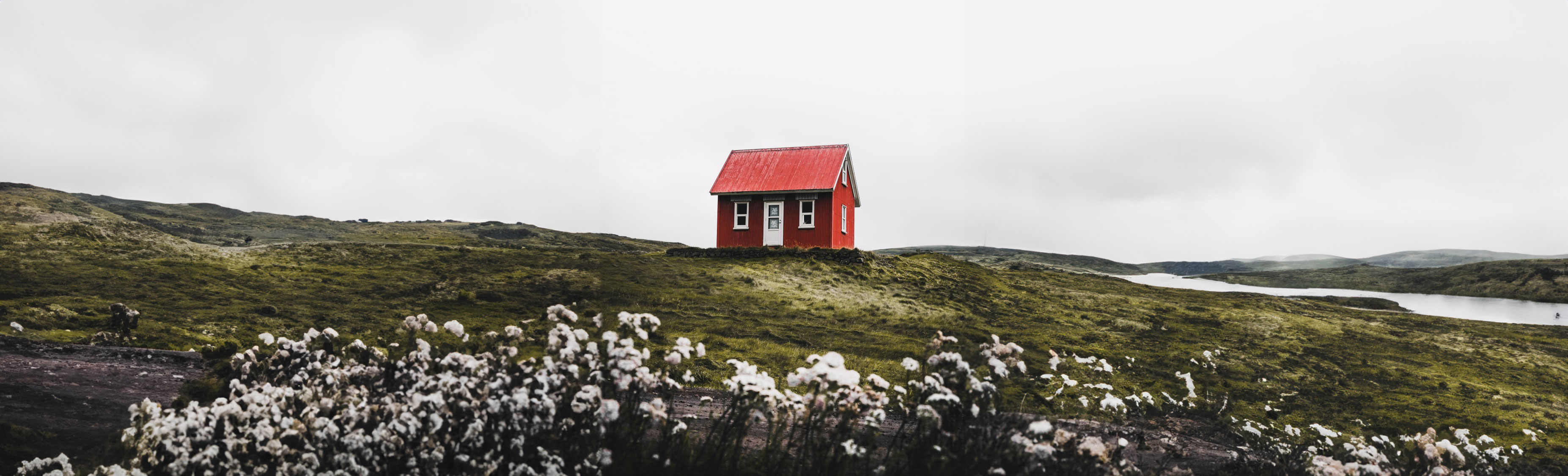 This is an image of a red house on a hill