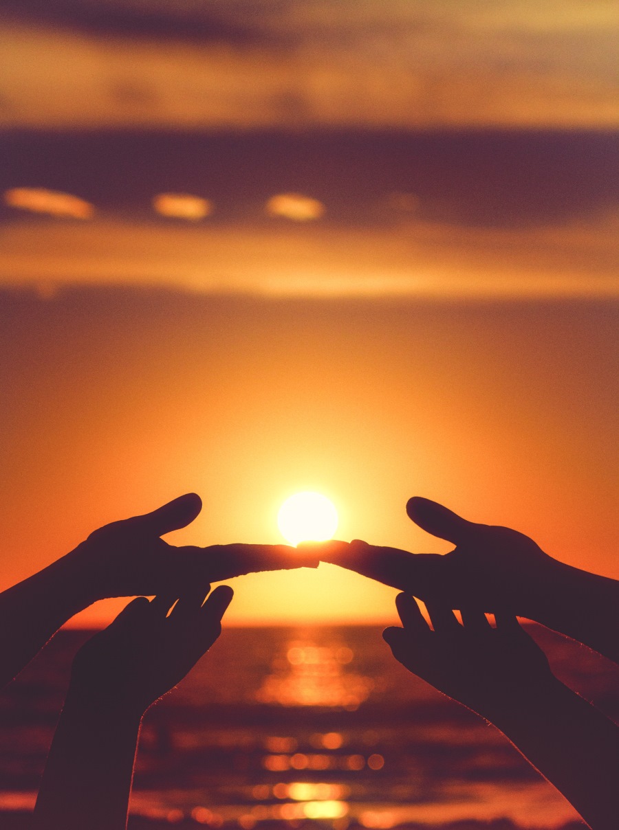 This is a picture of 2 people holding the sun