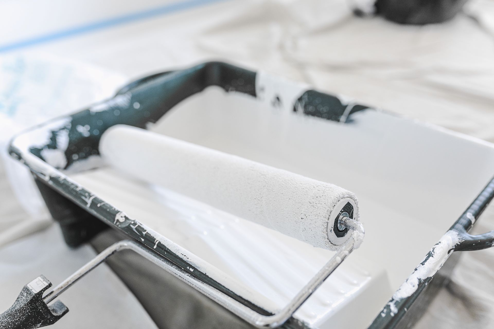 This is an image of a roller with white paint in it